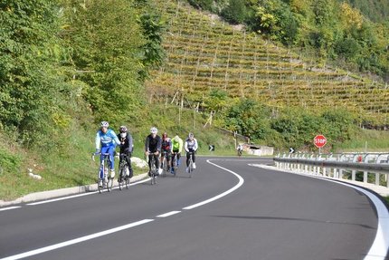 Groep fietsers op bergweg met stopbord