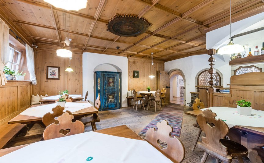 Cozy traditional tavern with wooden furniture and decorative blue cabinet