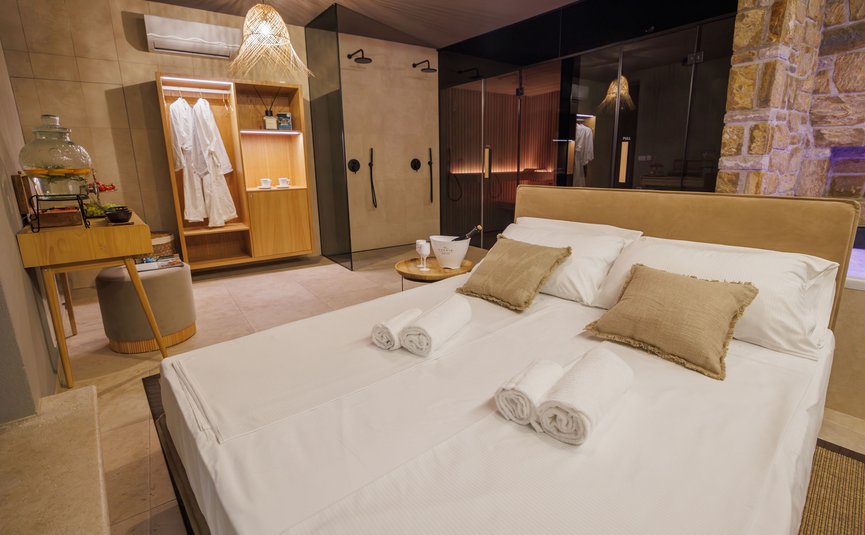 Modern hotel room with double bed, bathtub, and air conditioning