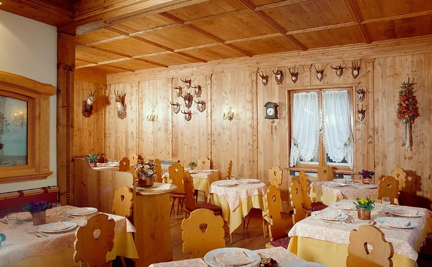 Rustic restaurant with wooden paneling and mounted trophies on walls