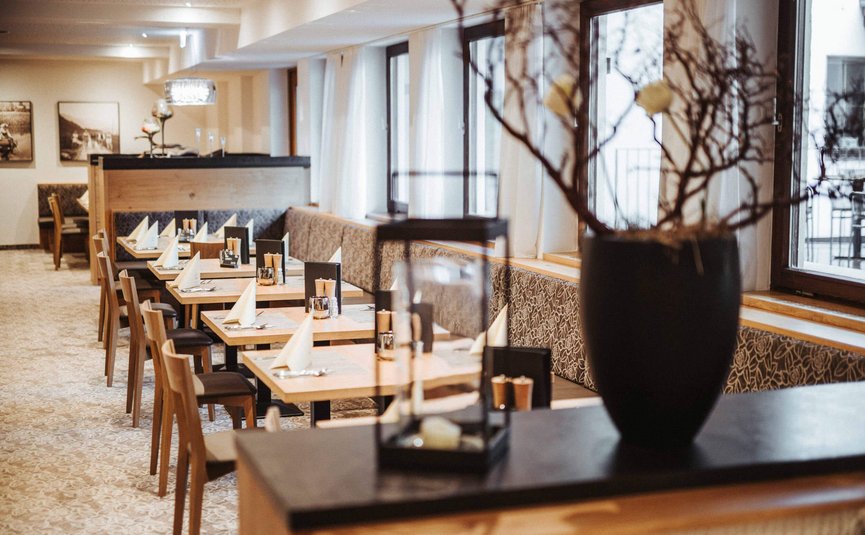 Restaurant with set wooden tables and chairs in a modern setting