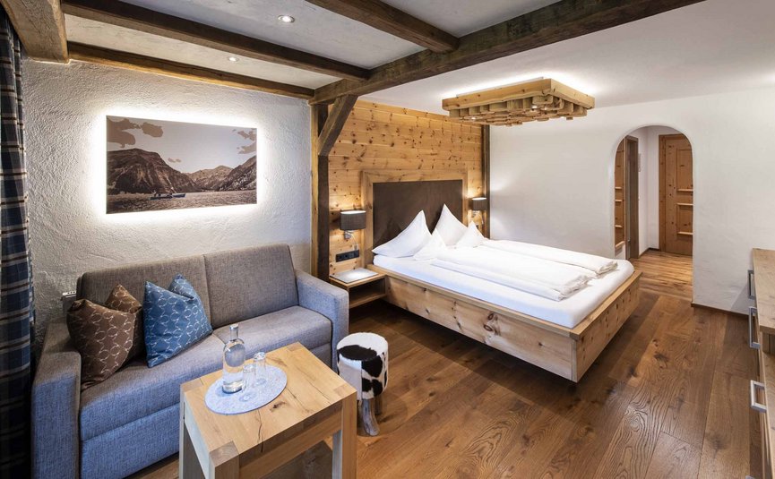 Cozy hotel room with wooden furniture and sofa