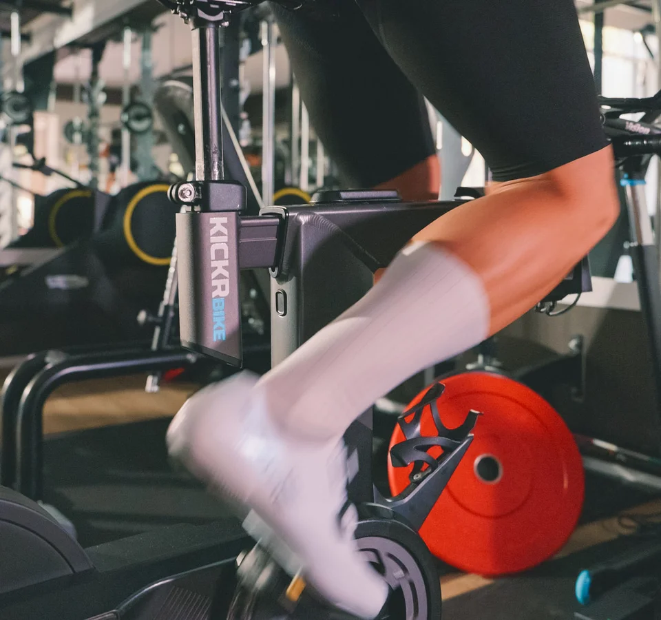 Triathlon hotels: Your base for training and recovery © Edelbaur Media Person cycling on indoor training bike at gym