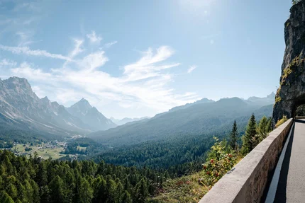Mountain road with tunnel and valley view under clear sky