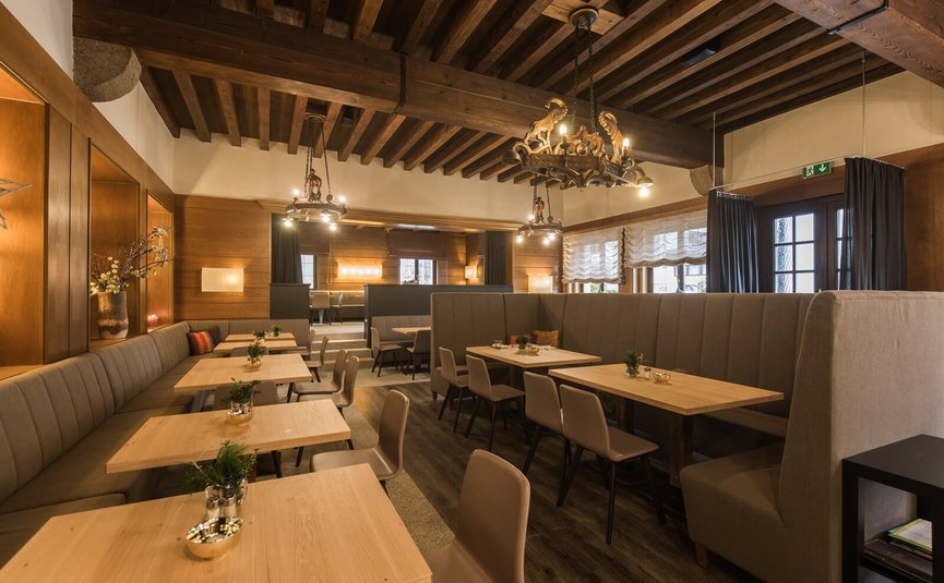 Cozy dining room with wooden tables and upholstered benches