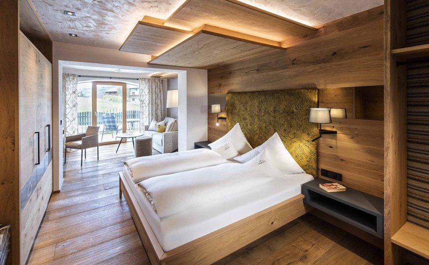 Modern hotel room with double bed and balcony view