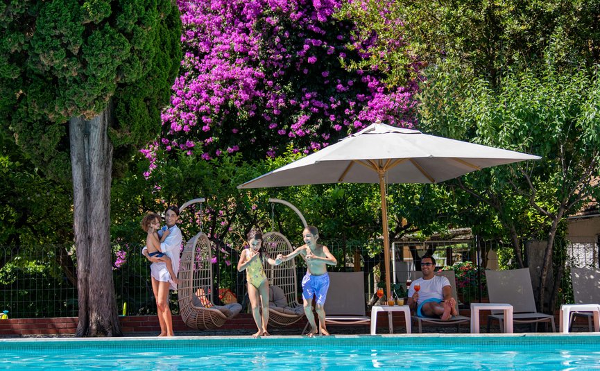 Family by the pool with kids ready to jump in