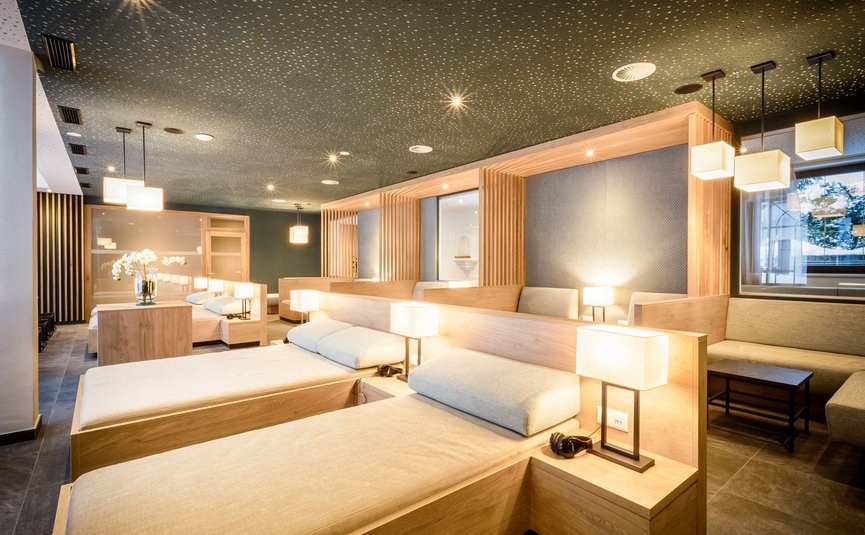 Bright modern wellness room with loungers and warm lamps