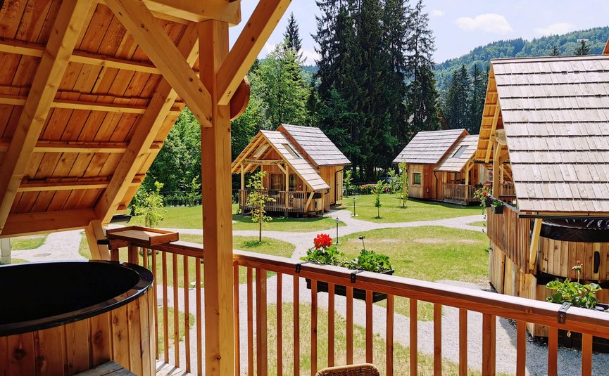 Vista da veranda in legno su piccole casette di legno e foresta