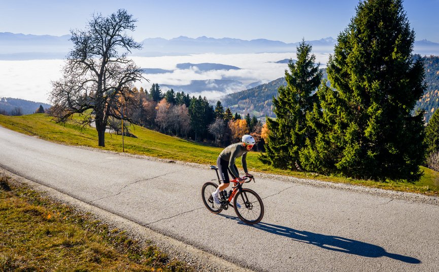 Road bike holiday in Central Carinthia © Michael Stabentheiner Cyclist riding on mountain road with foggy valley and mountains in background