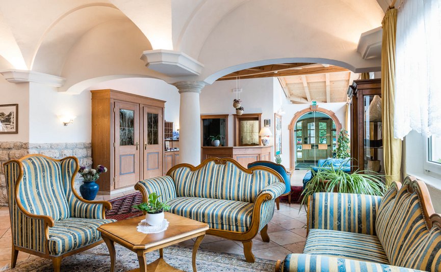 Bright hotel lobby with striped sofas and wooden furniture