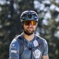 Man with helmet and sunglasses on mountain bike in the forest