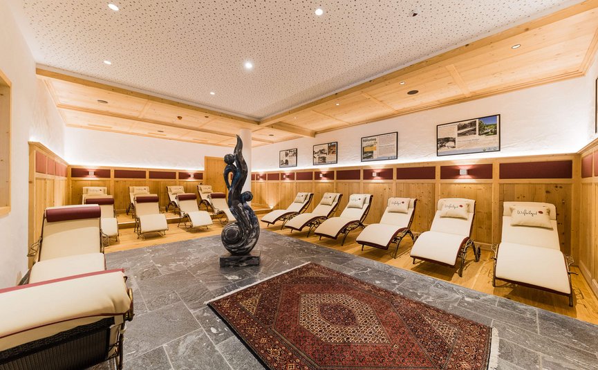 Relaxation room with lounge chairs and modern sculpture in a bright cozy design