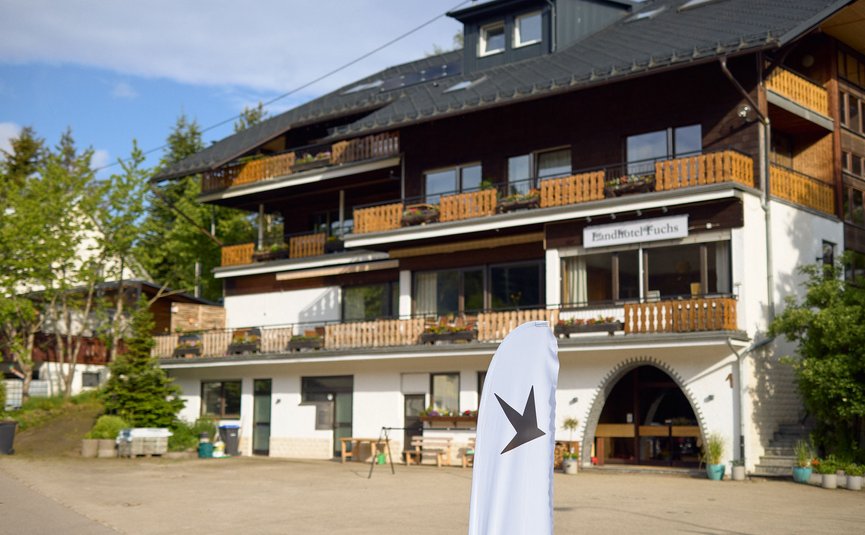Landhotel Fuchs © David Lemanski Exterior of Landhotel Fuchs with balconies and a white flag in front