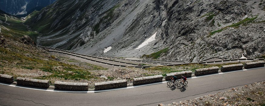 Grenzenlose Abenteuer in der Region Nauders - Reschensee © Felix Saller Zwei Radfahrer auf einer kurvenreichen Bergstraße in den Alpen