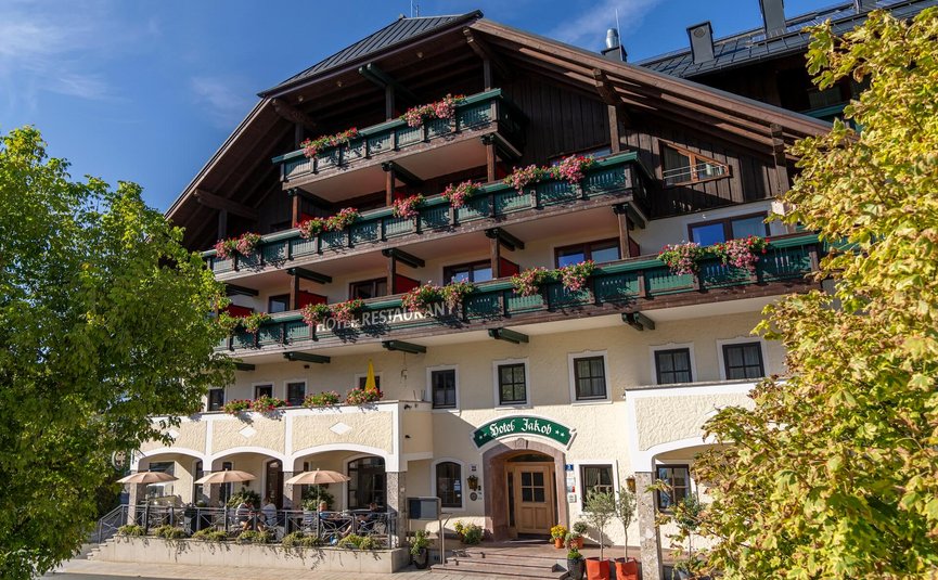 Traditional hotel with restaurant and flower-adorned balconies