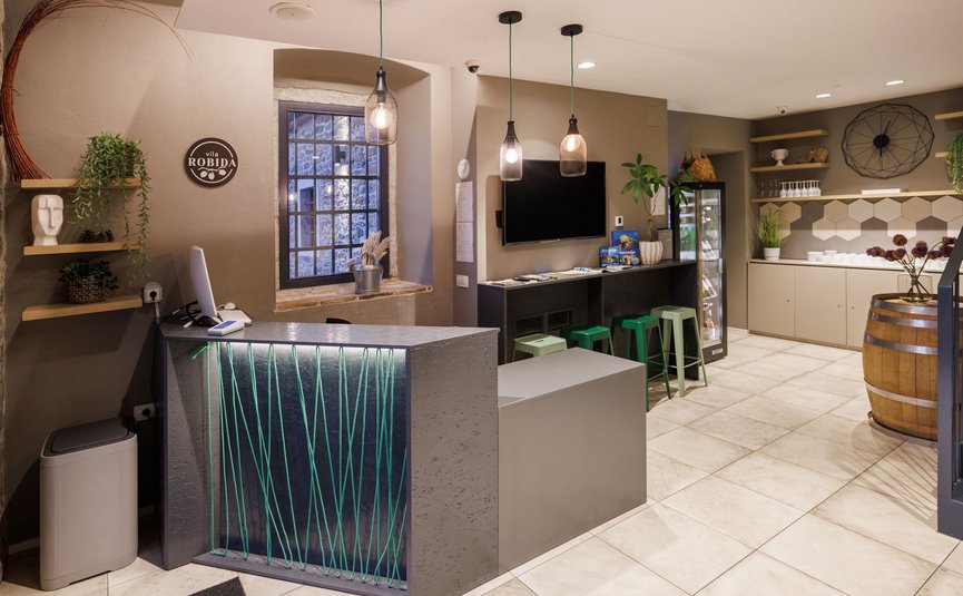 Reception area with desk, bar stools, and modern lighting