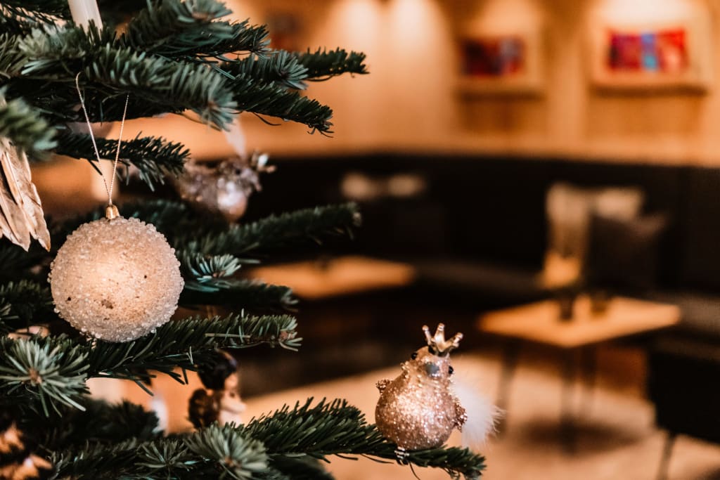 Close-up of a Christmas tree decorated with baubles and bird ornaments