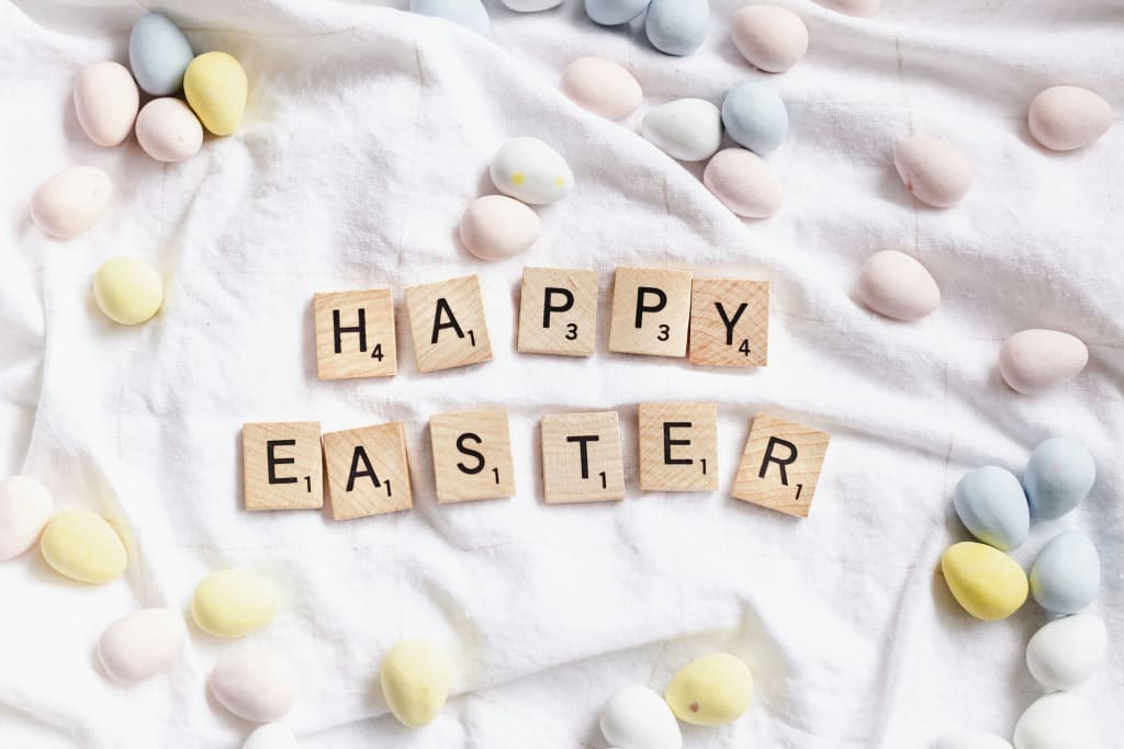 EASTER BY THE SEA Offer Scrabble letters spell Happy Easter on white cloth with pastel eggs