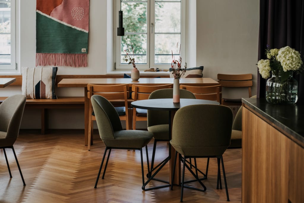 Gezellige eetruimte met stoelen, tafels en decoraties in warm licht