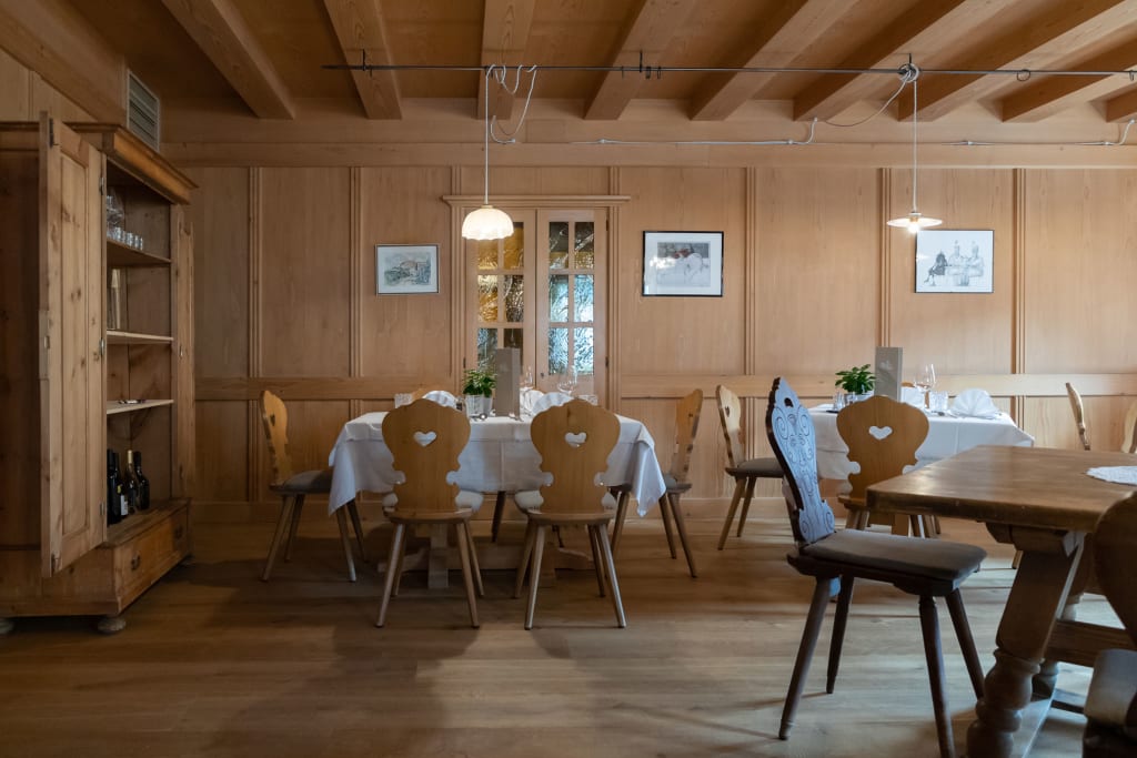 Traditional wooden restaurant with decorated tables and heart-shaped chairs